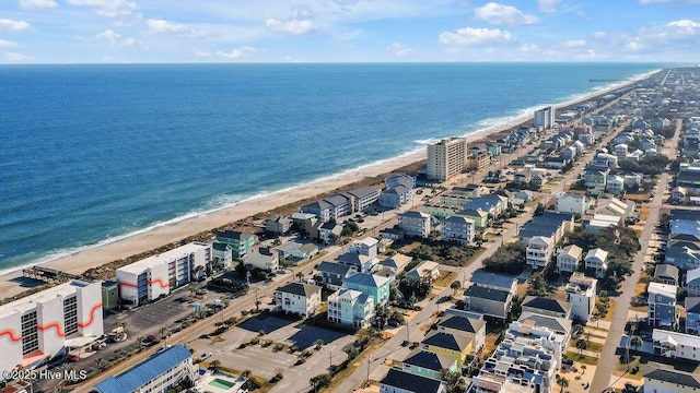 bird's eye view featuring a water view and a beach view