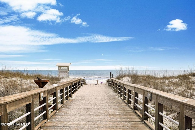 view of community with a water view and a beach view