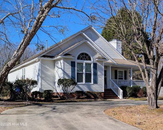 view of front of home featuring a porch and a chimney