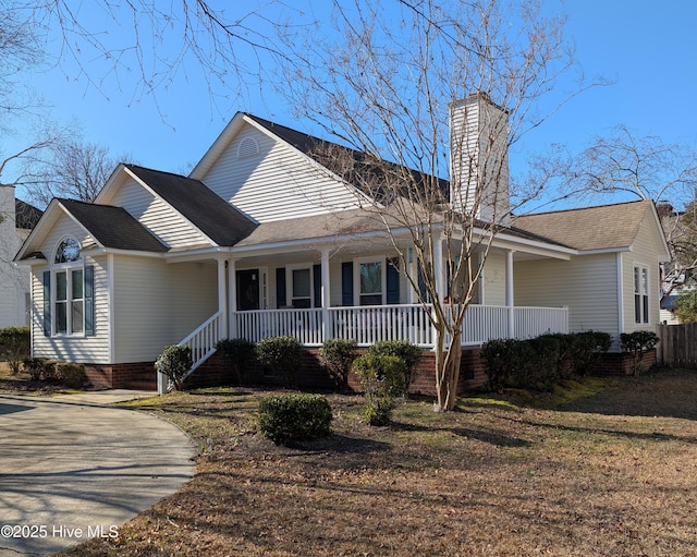 view of front of property featuring a chimney, covered porch, and crawl space