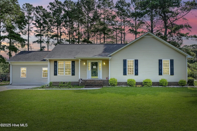 ranch-style home featuring a yard