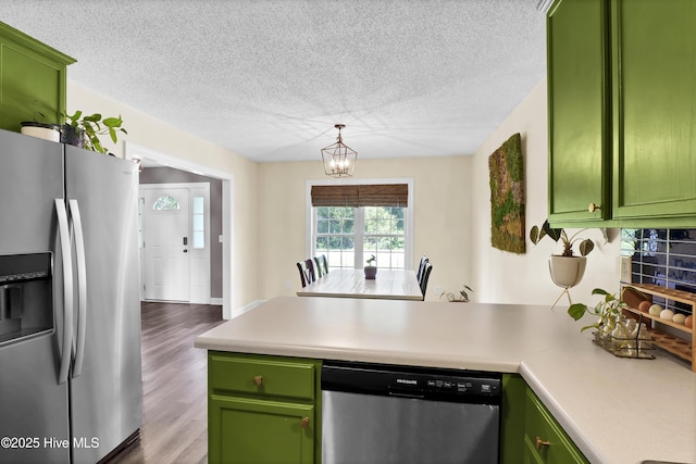 kitchen with appliances with stainless steel finishes and green cabinets