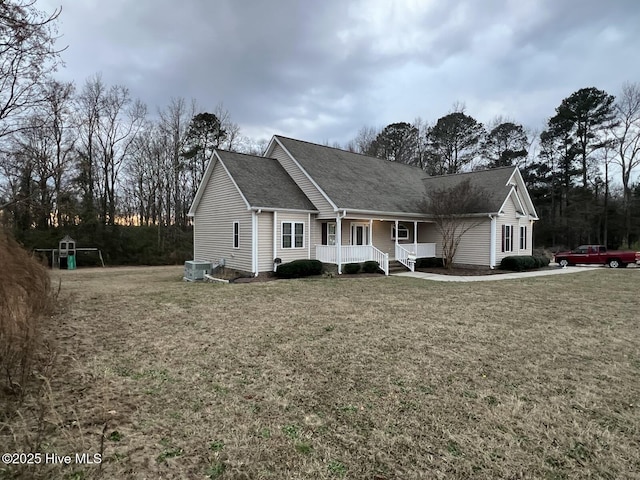 view of front of home with a porch, a front lawn, and central air condition unit