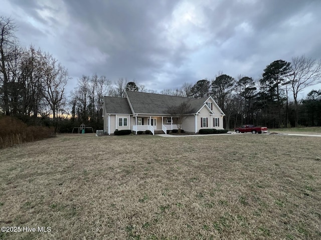 ranch-style home featuring a front yard and covered porch