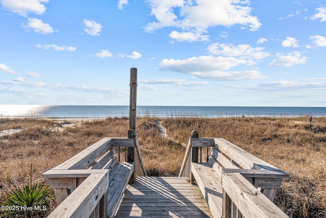 view of home's community with a water view and a view of the beach