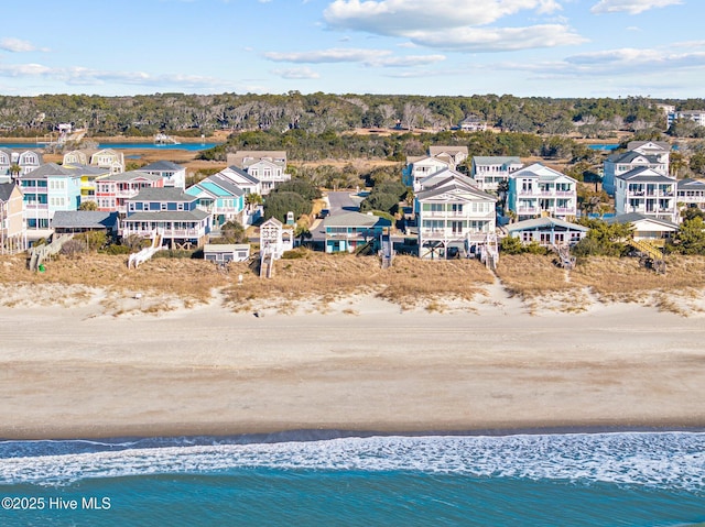 drone / aerial view with a water view and a beach view