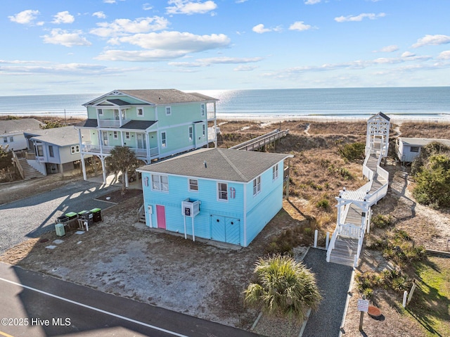 aerial view with a water view and a beach view