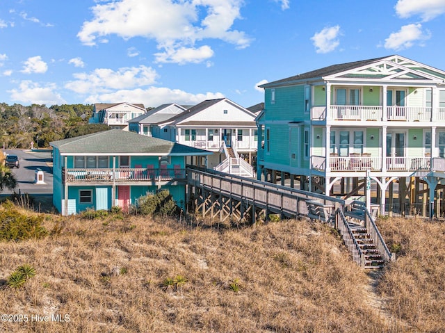 back of house featuring a balcony