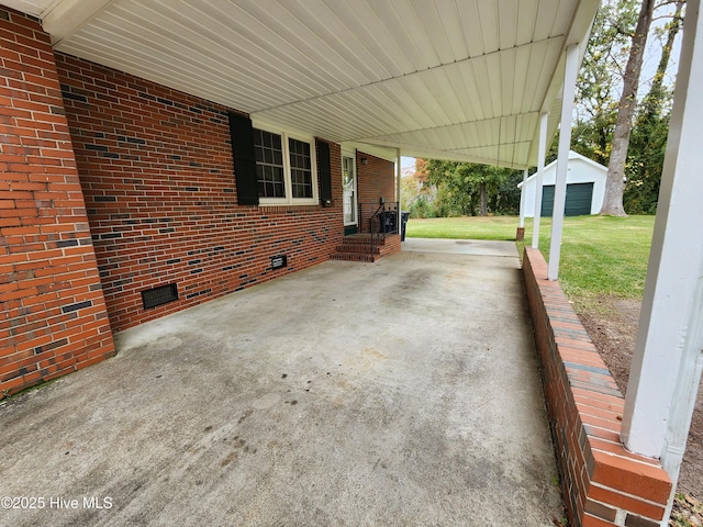 view of patio / terrace featuring an outbuilding and a garage