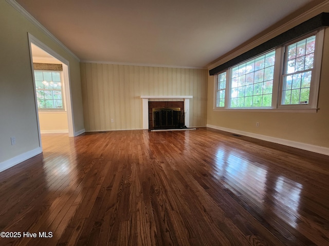 unfurnished living room with crown molding, a fireplace, and hardwood / wood-style floors