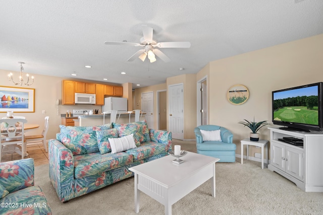 living room featuring a textured ceiling, light colored carpet, and ceiling fan with notable chandelier