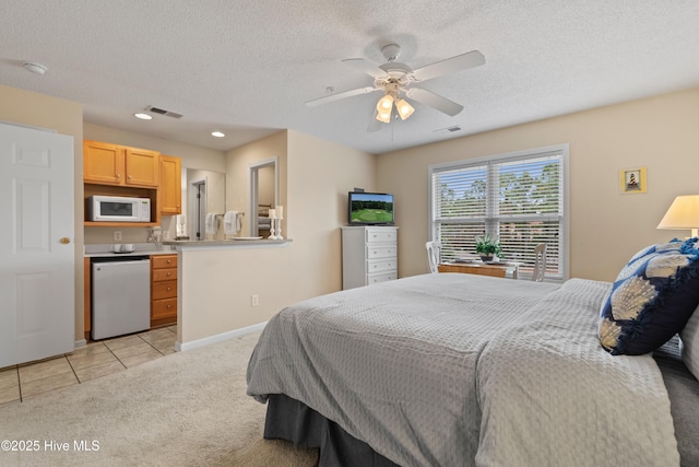 carpeted bedroom with ceiling fan and a textured ceiling