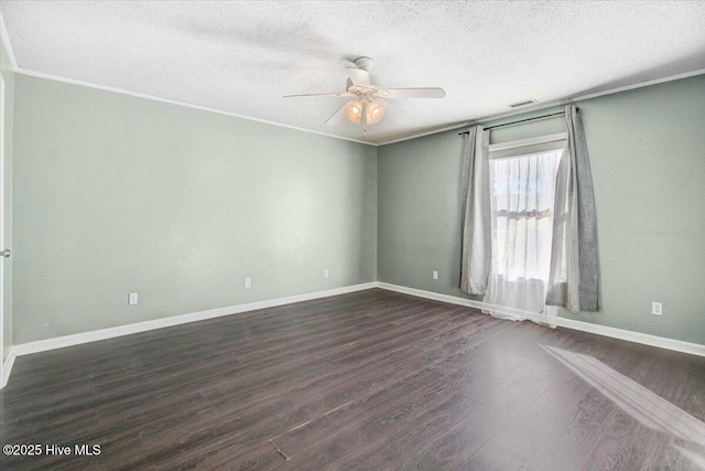 spare room featuring a textured ceiling, dark hardwood / wood-style floors, ceiling fan, and crown molding