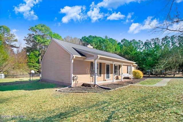 exterior space with covered porch and a front yard