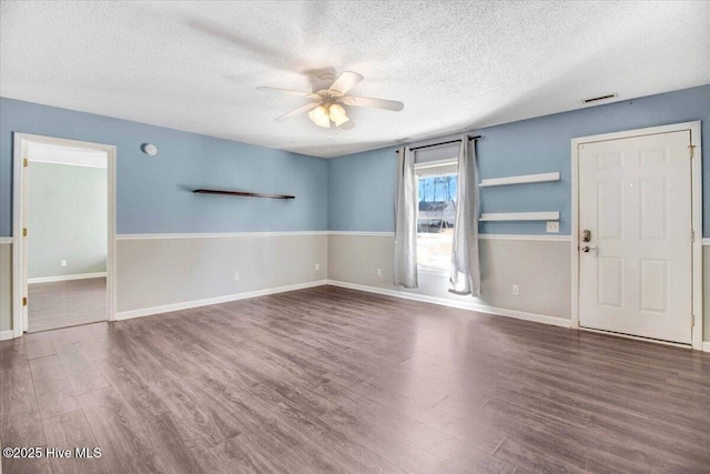 interior space featuring a textured ceiling, dark hardwood / wood-style floors, and ceiling fan