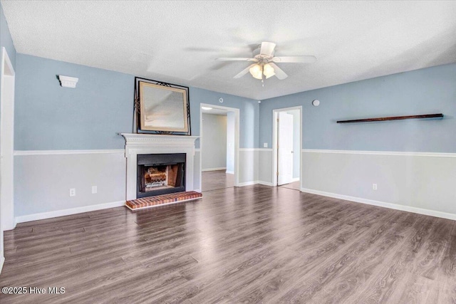 unfurnished living room featuring wood-type flooring, a textured ceiling, and ceiling fan