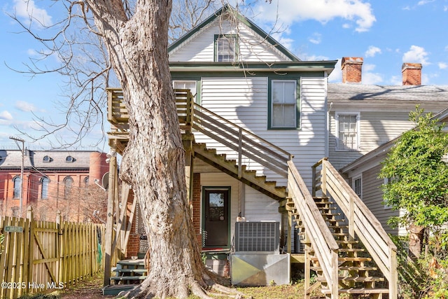 rear view of property with central AC unit