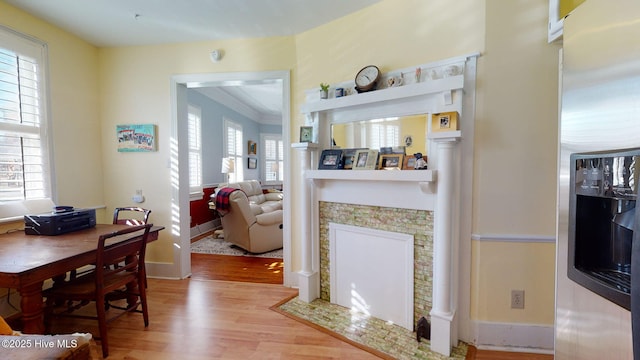 dining room featuring wood-type flooring and ornamental molding