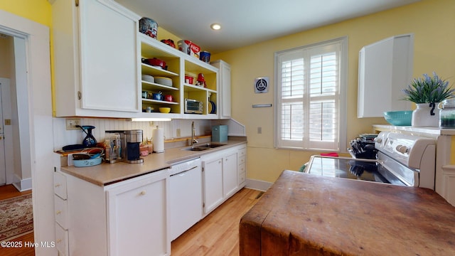 kitchen featuring white cabinets, white appliances, sink, and light hardwood / wood-style flooring