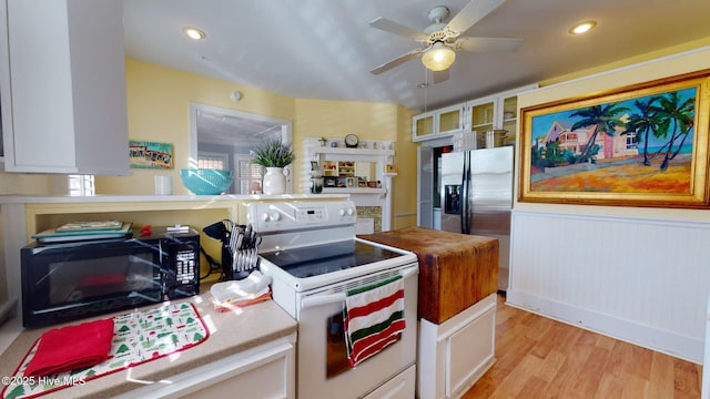 kitchen featuring ceiling fan, stainless steel fridge with ice dispenser, light hardwood / wood-style flooring, white range with electric stovetop, and white cabinets