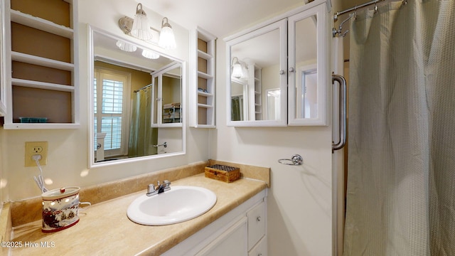 bathroom with a shower with shower curtain and vanity