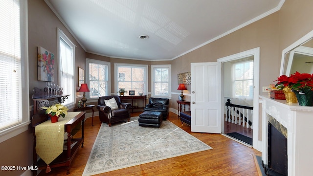 sitting room featuring hardwood / wood-style flooring and crown molding