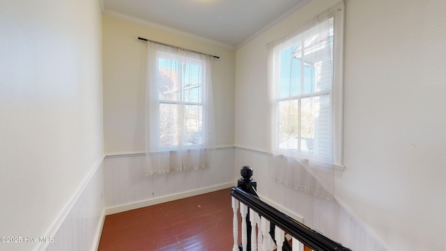 corridor with dark hardwood / wood-style floors and crown molding