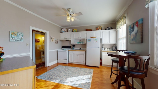 kitchen featuring white appliances, ceiling fan, crown molding, light hardwood / wood-style flooring, and white cabinets