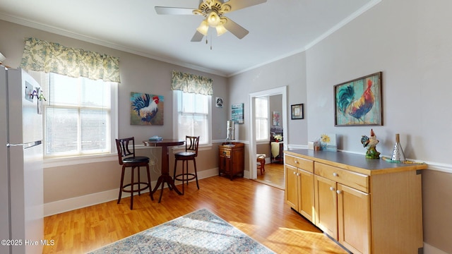 interior space with ceiling fan, white fridge, a healthy amount of sunlight, and light hardwood / wood-style floors