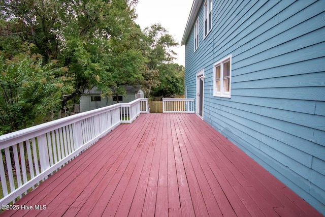 wooden deck featuring a storage unit