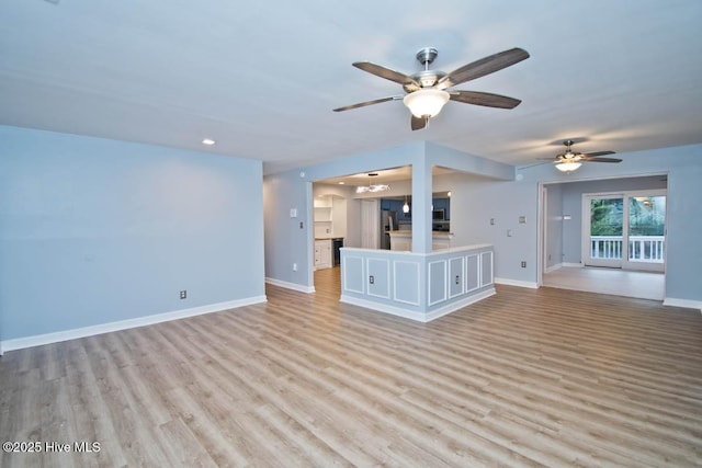 unfurnished living room with ceiling fan and light hardwood / wood-style floors