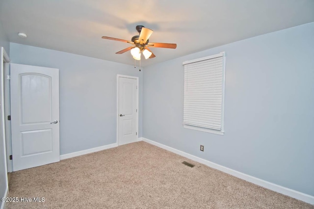 empty room with light carpet and ceiling fan