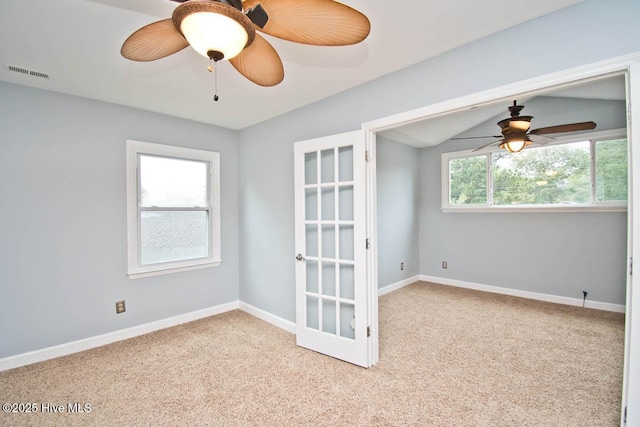 unfurnished room with ceiling fan, light colored carpet, and lofted ceiling