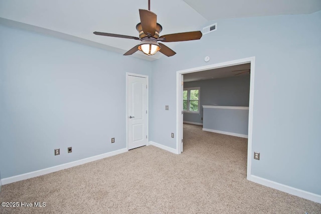 unfurnished room with ceiling fan, lofted ceiling, and light carpet