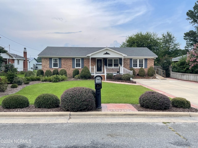 ranch-style house with a front yard and a porch