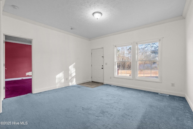 unfurnished room with crown molding, carpet floors, and a textured ceiling