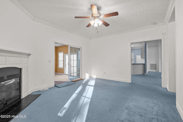 carpeted living room featuring a fireplace, a textured ceiling, ceiling fan, and crown molding