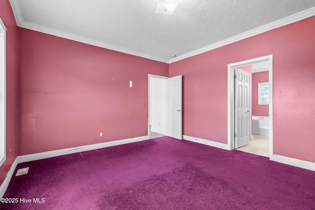 unfurnished bedroom featuring ensuite bathroom, crown molding, a textured ceiling, and light carpet