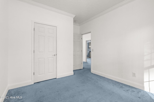 unfurnished bedroom featuring carpet flooring, a textured ceiling, and ornamental molding