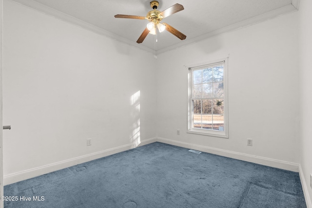 carpeted spare room featuring crown molding and ceiling fan