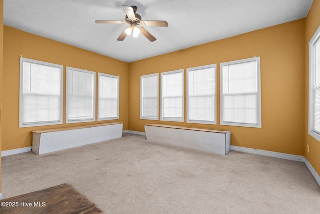 carpeted empty room with ceiling fan