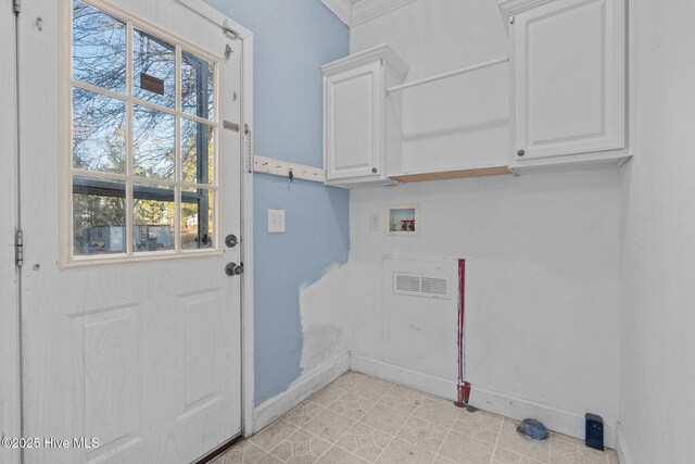 clothes washing area featuring washer hookup and cabinets