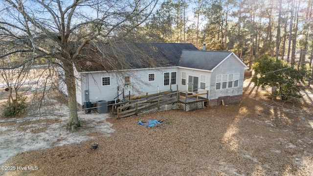 rear view of property with a deck and central air condition unit