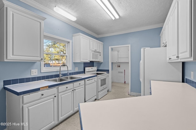 kitchen featuring white cabinets, white appliances, and sink