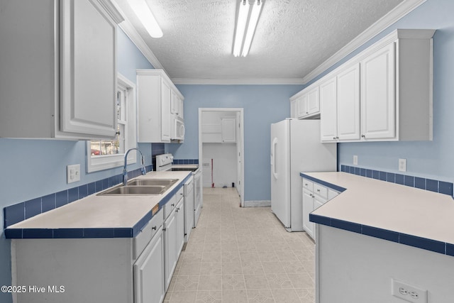 kitchen featuring white cabinets, a textured ceiling, white appliances, and sink