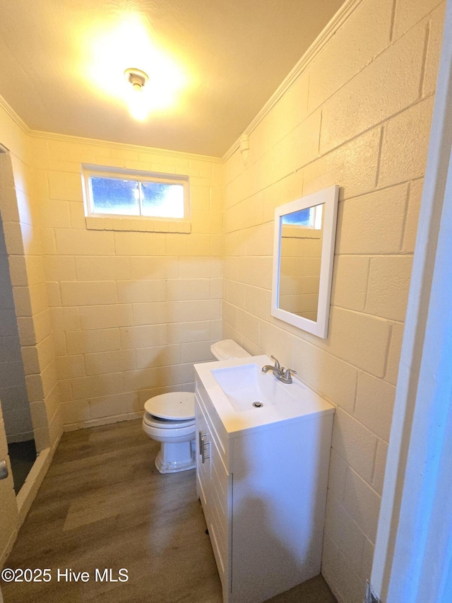 bathroom with hardwood / wood-style flooring, vanity, toilet, and ornamental molding