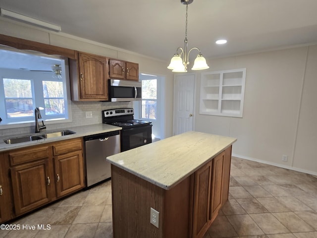 kitchen with decorative backsplash, appliances with stainless steel finishes, sink, decorative light fixtures, and a center island