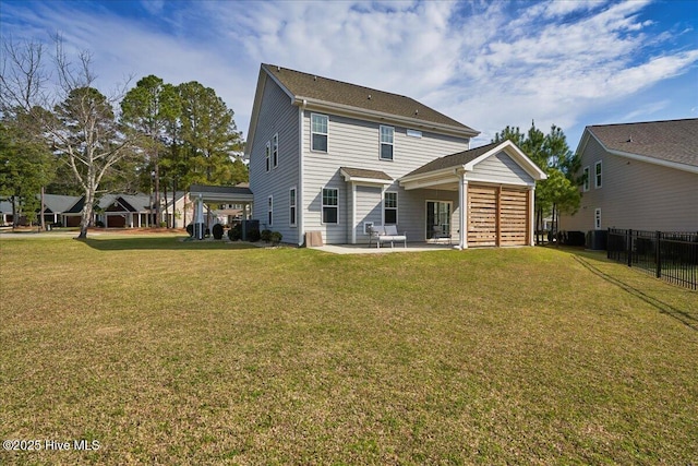 back of house featuring a patio area and a yard