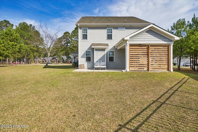 back of property featuring a patio area and a yard