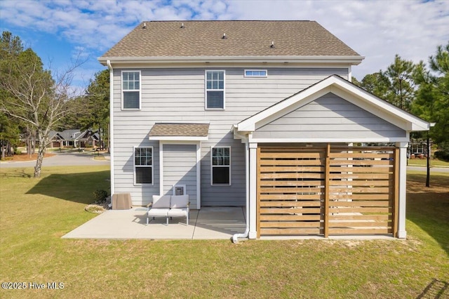 rear view of house featuring a patio area and a lawn